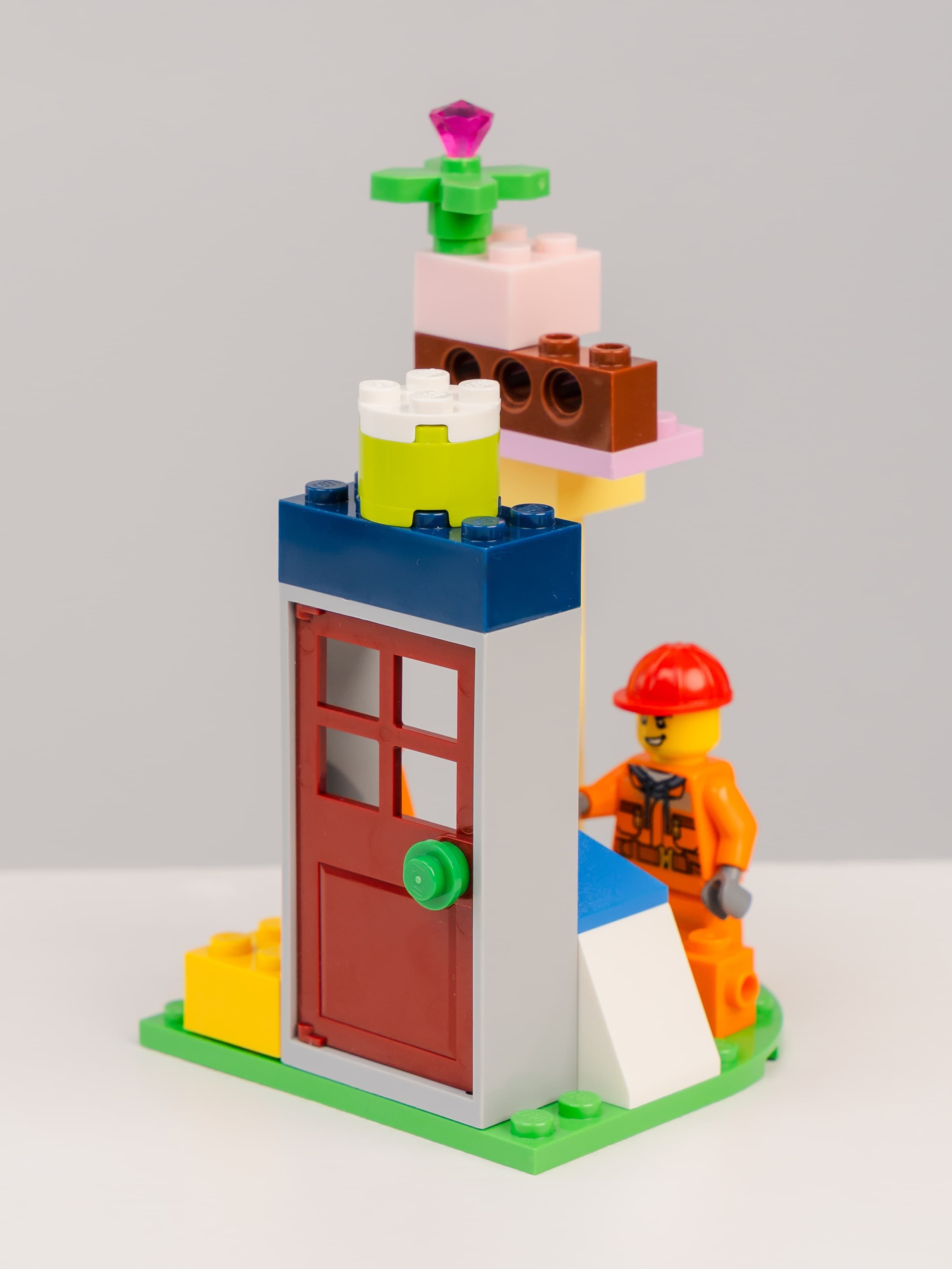 A small LEGO construction model with a red door